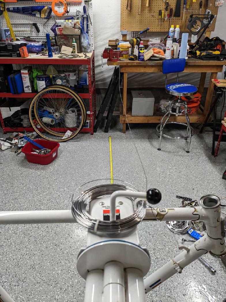 Measuring the piano wire with a bicycle stand.