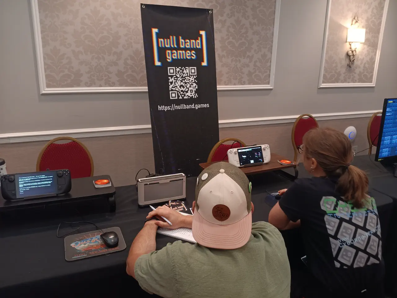 An attendee playtesting The Patchwork Ship and giving feedback to Jon