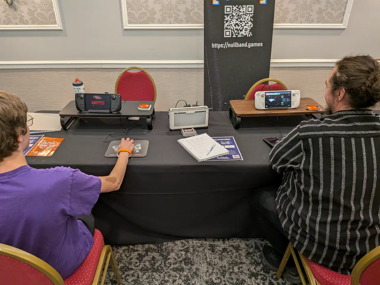 Two expo attendees playtesting The Patchwork Ship