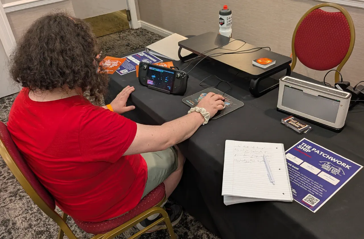 An expo attendee engrossed in playtesting The Patchwork Ship