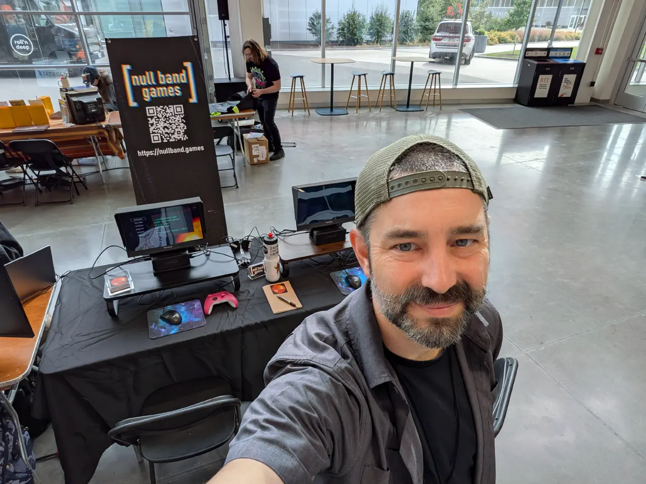 Jon Peck in front of the booth for The Patchwork Ship