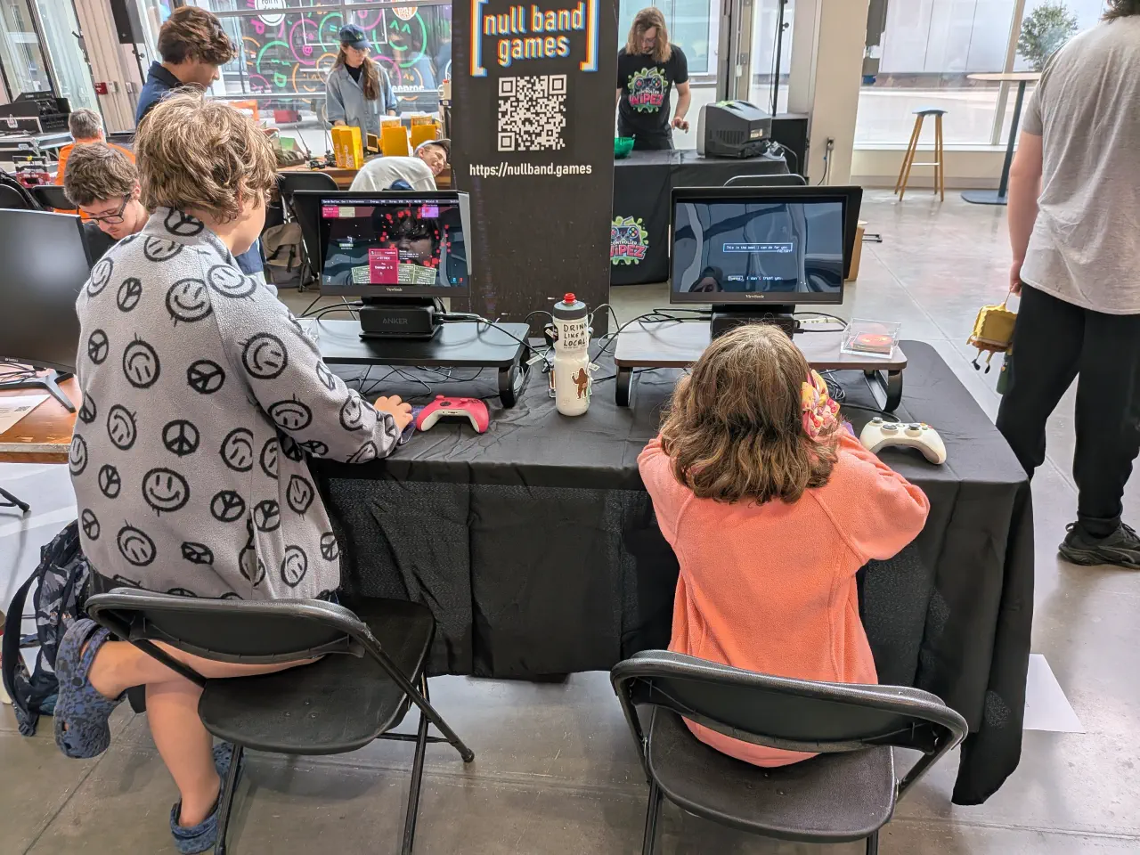Two people playing The Patchwork Ship at the Null Band Games booth