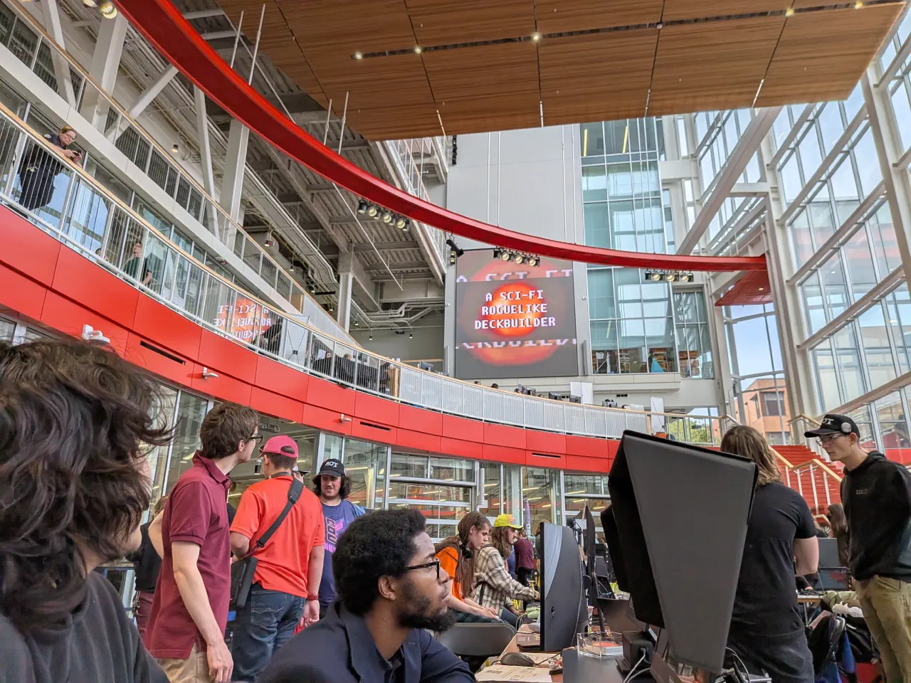 The first trailer for The Patchwork Ship being projected at the RocGameFest expo while attendees look on and do expo things